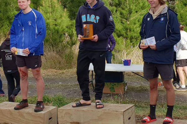 Liam Thompson (captain) collecting the Top Boys School trophy for NZSS Orienteering.